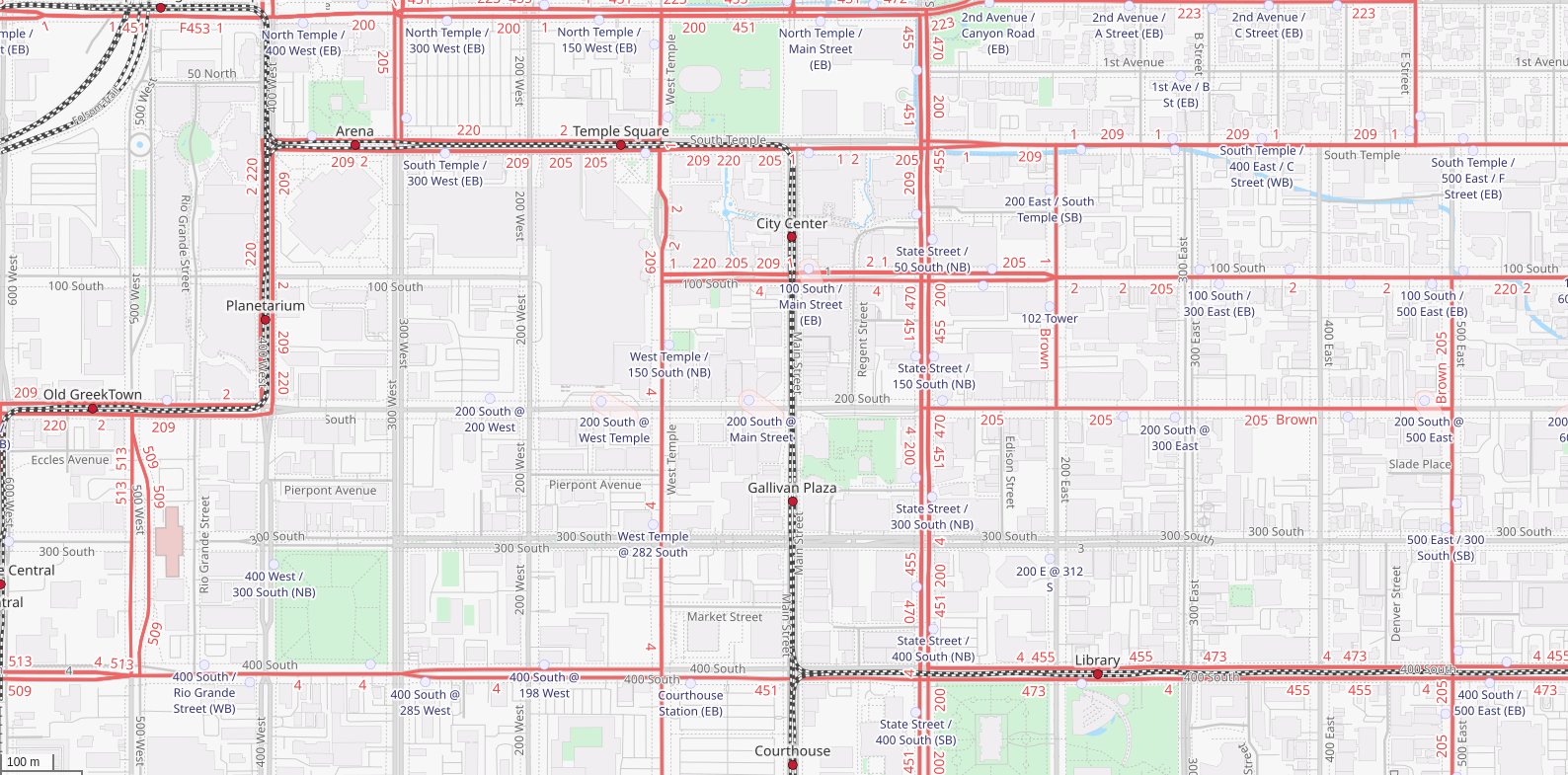 Salt Lake City on openstreetmap.org in the Transport Map style. Bus routes are drawn with red lines, and rails in dashed black, with everything else more faded than other styles.
